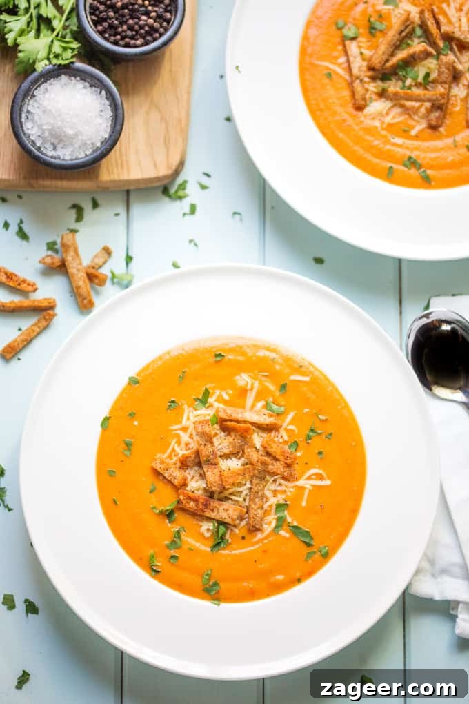 Wholesome Red Pepper Lentil Soup with Crunchy Wholemeal Pita 2 A comforting bowl of wholesome Lentil and Red Pepper Soup served with crunchy wholemeal pita crisps on the side, showcasing its vibrant red color and delicious texture.