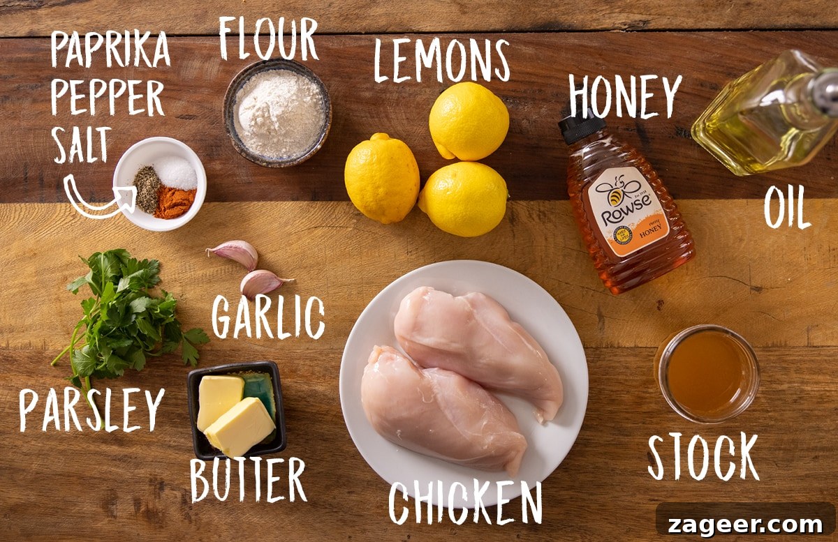 Zesty Honey Glazed Chicken 3 A rustic wooden table displaying all the fresh ingredients needed for honey lemon chicken, including chicken breasts, lemons, honey, garlic, and various spices.