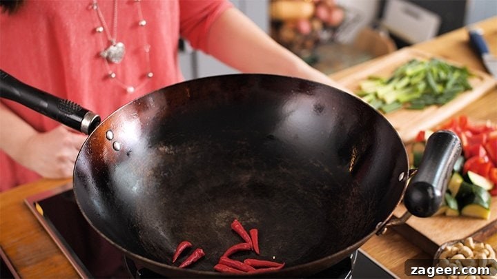 Szechuan Chili Peanut Chicken 6 Dry-frying whole red chili peppers in a hot wok for Kung Pao Chicken to release their heat and aroma.