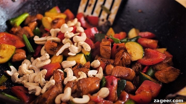 Szechuan Chili Peanut Chicken 8 Close-up view of Kung Pao Chicken stir-frying in a wok, showing the rich sauce, chicken, vegetables, and nuts.