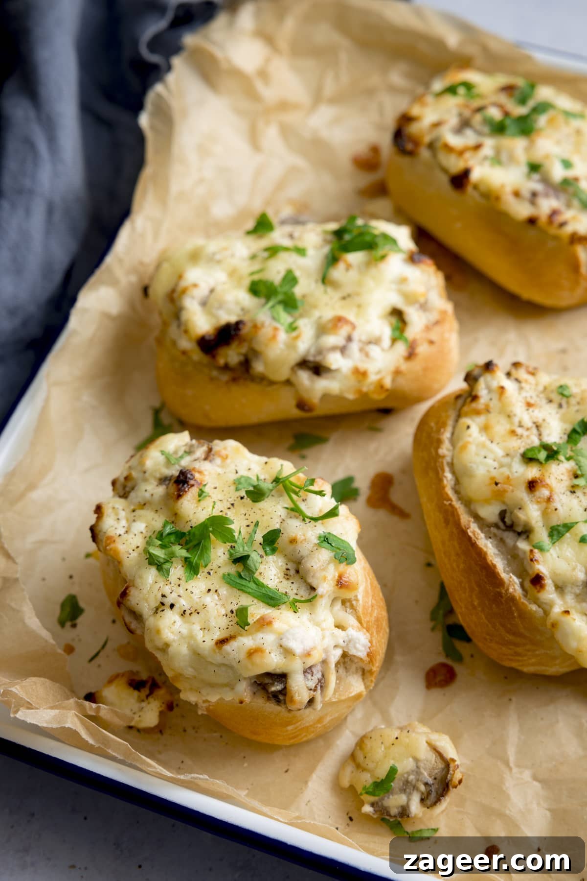 Luscious Creamy Garlic Mushroom Stuffed Rolls 5 Cheesy Mushroom Stuffed Garlic Breads on a tray lined with baking parchment.