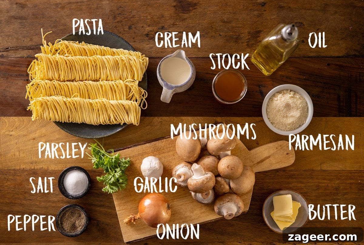 Velvety Mushroom Pasta 3 All the fresh ingredients for creamy mushroom pasta, neatly arranged on a rustic wooden table, ready for preparation.