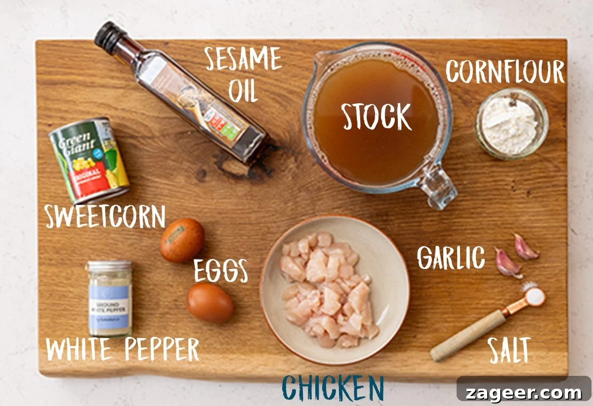 Savory Chicken and Sweet Corn Delight 3 Ingredients for chicken and sweetcorn soup on a wooden board.