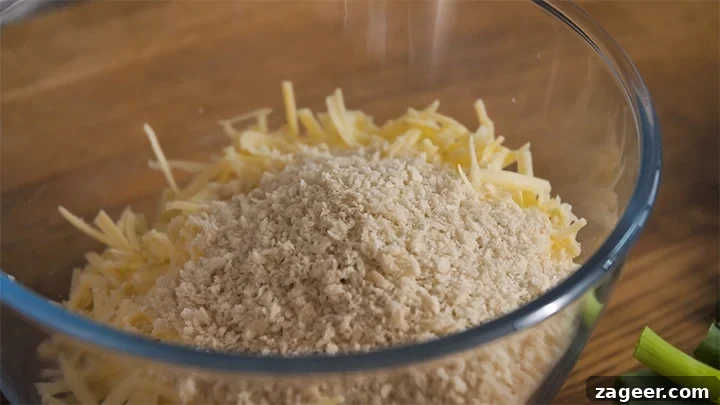 The Secret to Vegetarian Sausage Rolls That Meat Eaters Crave 4 Grated cheddar cheese and panko breadcrumbs thoroughly mixed in a white bowl.