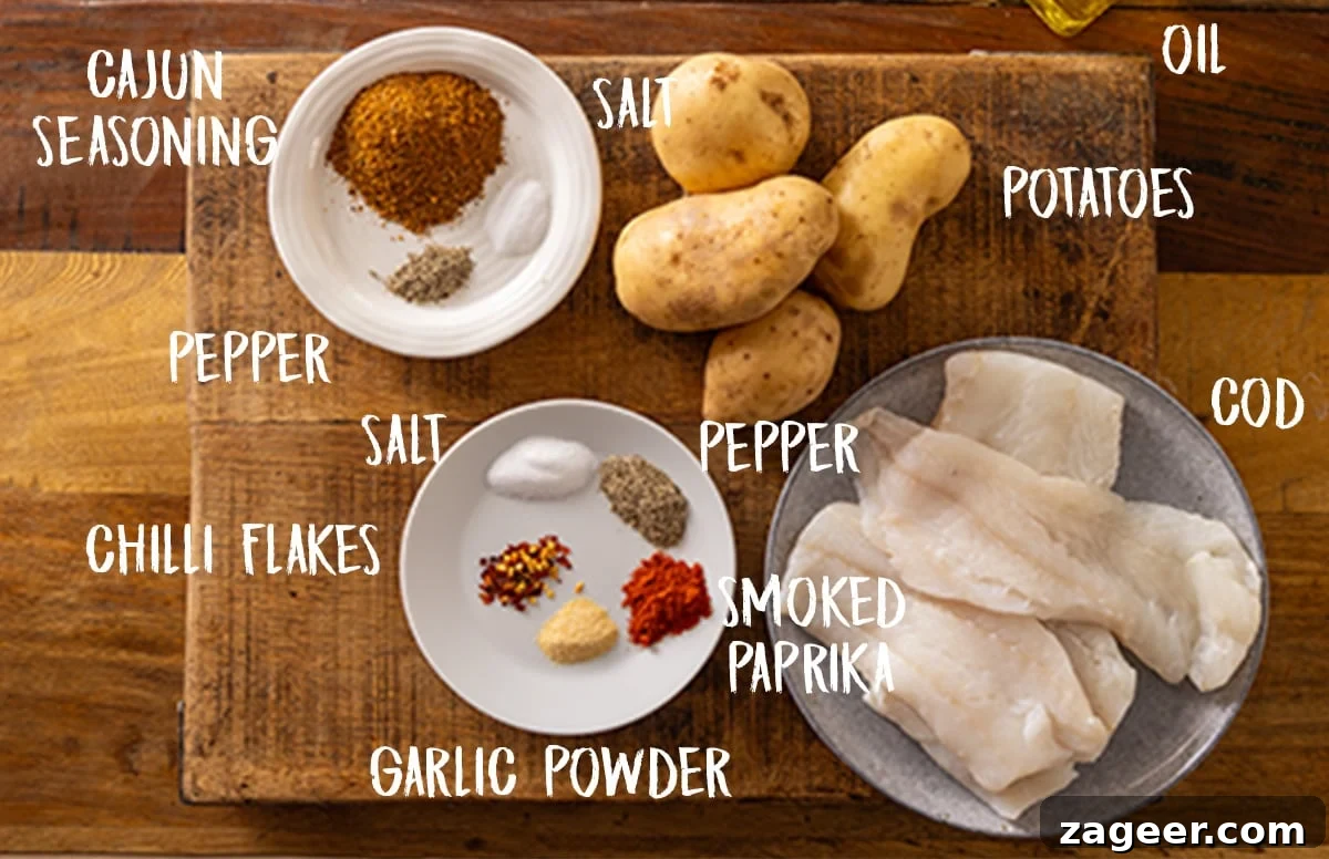 Zesty Cajun Cod and Smoky Roasted Potatoes 3 A neatly arranged flat lay of all the essential ingredients on a rustic wooden chopping board. Labels indicate: Potatoes, Cod, Olive Oil, Salt, Pepper, Smoked Paprika, Garlic Powder, Chilli Flakes, and Cajun Seasoning, ready for preparation.