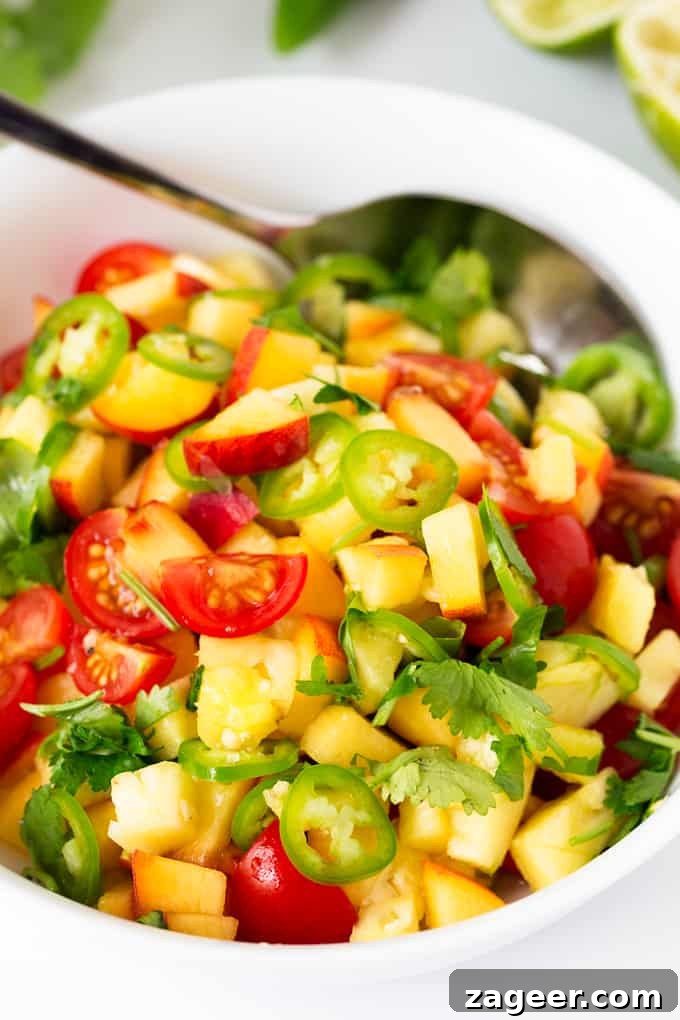 Sunshine Peach Pineapple Salsa 3 Close-up of fresh Peach and Pineapple Salsa with a Jalapeño kick in a white bowl.