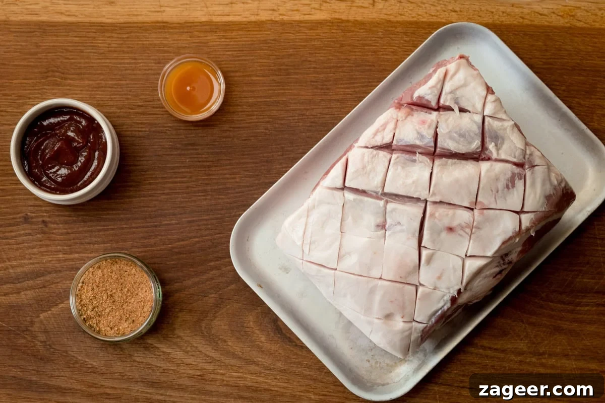 Slow-Cooked BBQ Pork Perfection 3 A wide, overhead shot of the ingredients for BBQ Pulled Pork. The ingredients are laid out on a wooden board. They are as follows: Pork shoulder, BBQ sauce, apple cider vinegar, and the rub.