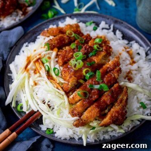 Tonkatsu pork on a plate with rice and cabbage