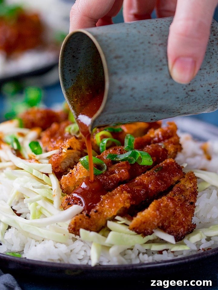 Fiery Crispy Tonkatsu 5 Tonkatsu curry sauce being poured onto pork katsu