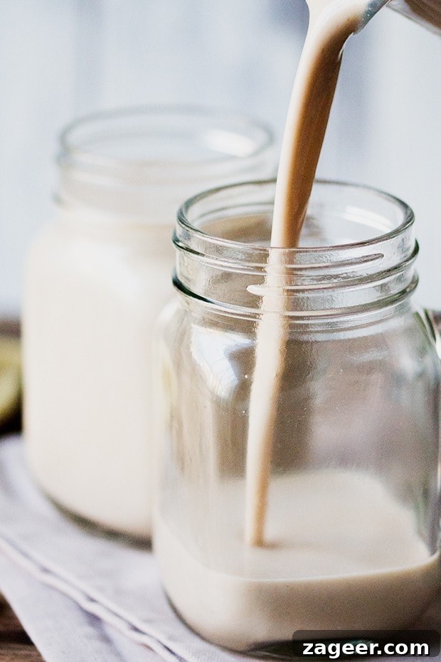 Creamy Hot White Chocolate Coconut Cashew Smoothie 3 White Chocolate Coconut Cashew Hot Smoothie being poured into a stylish kilner jar
