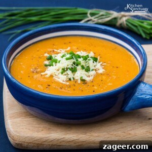 Close-up view of the rich and golden Cheesy Butternut Squash Soup, highlighting its creamy texture.