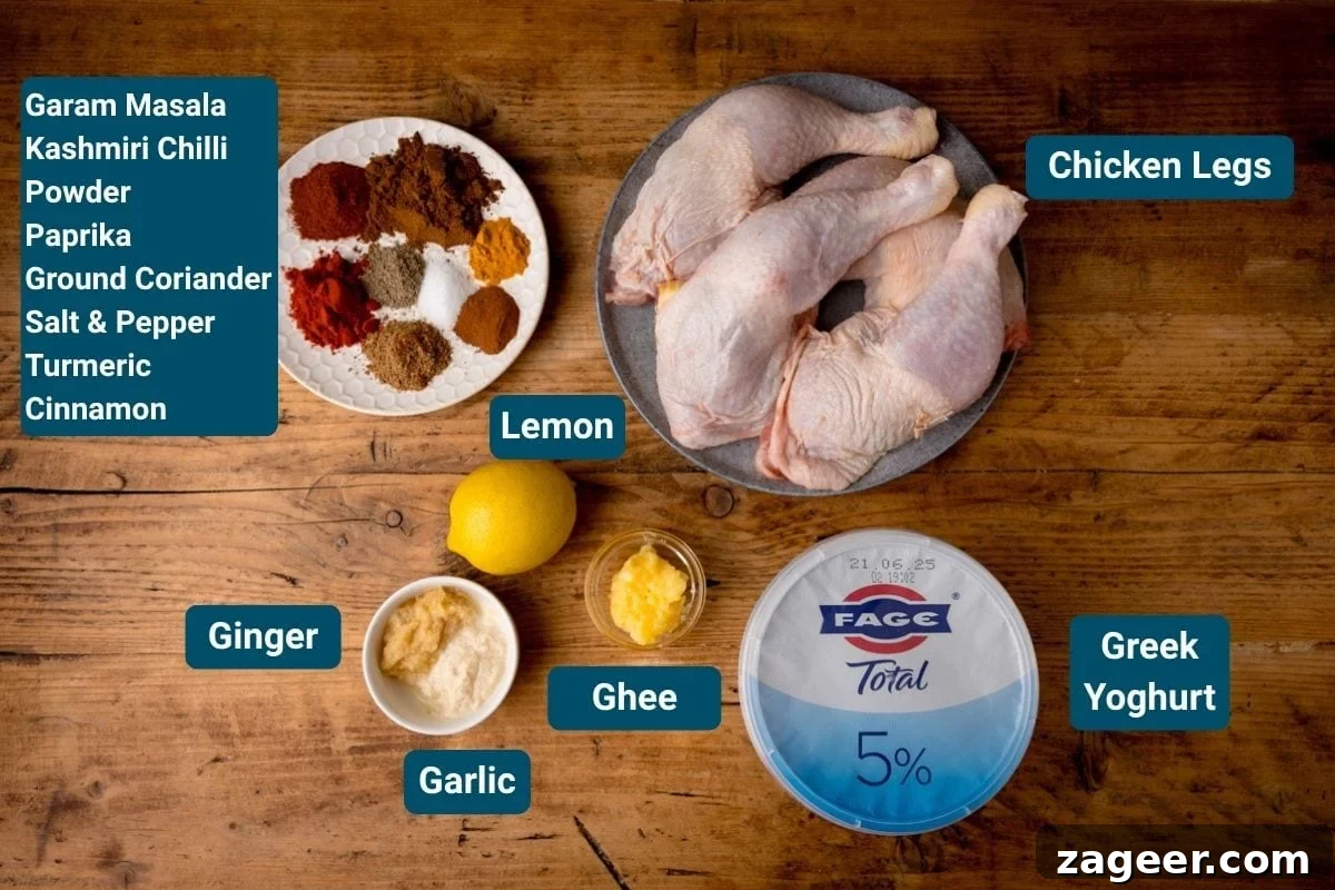 Ultimate Tandoori Chicken Recipe 4 Chicken legs, Greek yoghurt, ghee, garlic, ginger, lemon, and assorted spices including garam masala, chilli powder, paprika, coriander, salt, pepper, turmeric and cinnamon on a wooden surface, ready for marination.