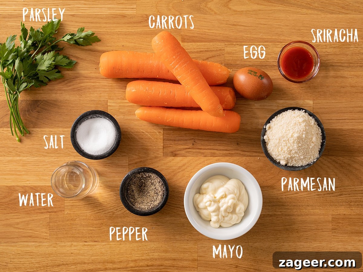 Golden Parmesan Carrot Fries 3 Ingredients for baked parmesan carrot fries laid out on a wooden table, including fresh carrots, an egg, grated parmesan, salt, pepper, mayonnaise, and sriracha sauce.
