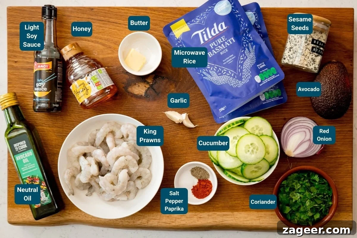 Garlic Honey Shrimp Rice Bowls 4 A wooden board topped with labelled ingredients for honey garlic prawn rice bowls: king prawns, rice, butter, oil, soy sauce, honey, garlic, cucumber, paprika, salt, pepper, coriander, onion, avocado and sesame seeds.