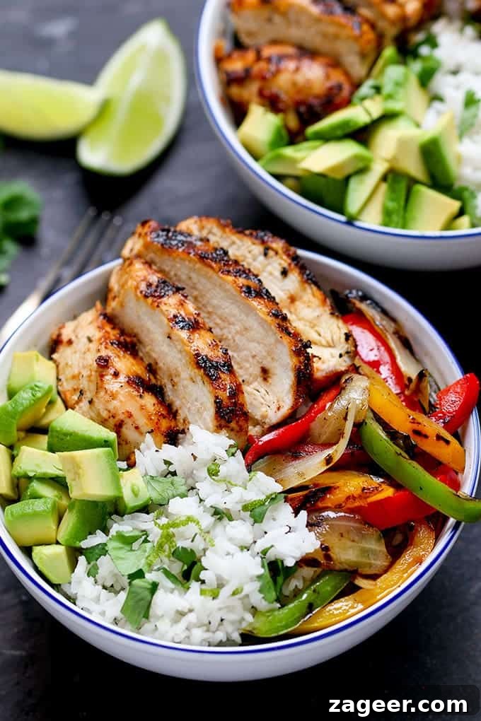 Bright Cilantro Lime Rice with Fiery Cajun Chicken 3 Close-up photo of juicy griddled Cajun chicken with vibrant charred veggies and fragrant coriander-lime rice in a serving bowl.