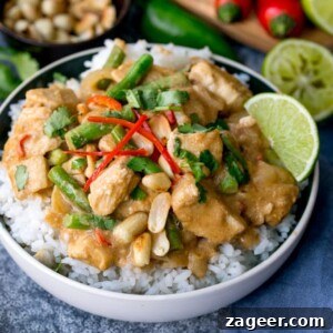 20-Minute Creamy Peanut Chicken 2 Bowl of rice topped with vibrant peanut butter chicken, tender green beans, and fresh coriander.