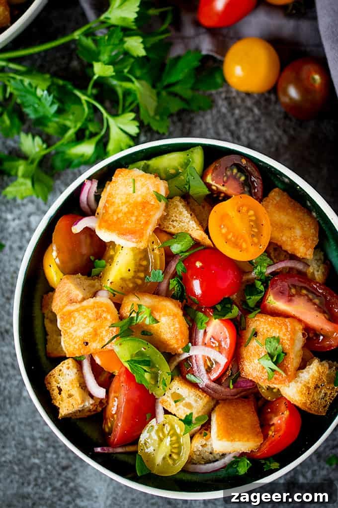 Flaming Saganaki Panzanella 4 Panzanella Salad with Saganaki - Italy meets Greece in this juicy Tuscan tomato salad with crispy fried Greek cheese.