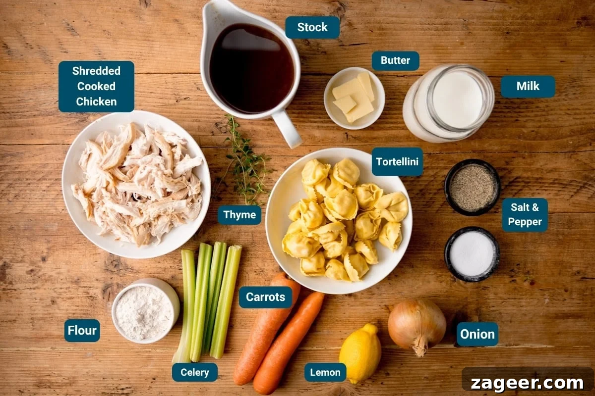 Velvet Chicken Tortellini Comfort 4 A vibrant flat lay showcasing all the fresh ingredients needed for a Creamy Chicken and Tortellini Soup. Shredded cooked chicken, golden chicken stock, rich butter, creamy milk, salt and pepper, aromatic onion, bright lemon, crisp carrots, tender celery, all-purpose flour, fragrant thyme, and delicate tortellini are arranged beautifully on a rustic wooden table.