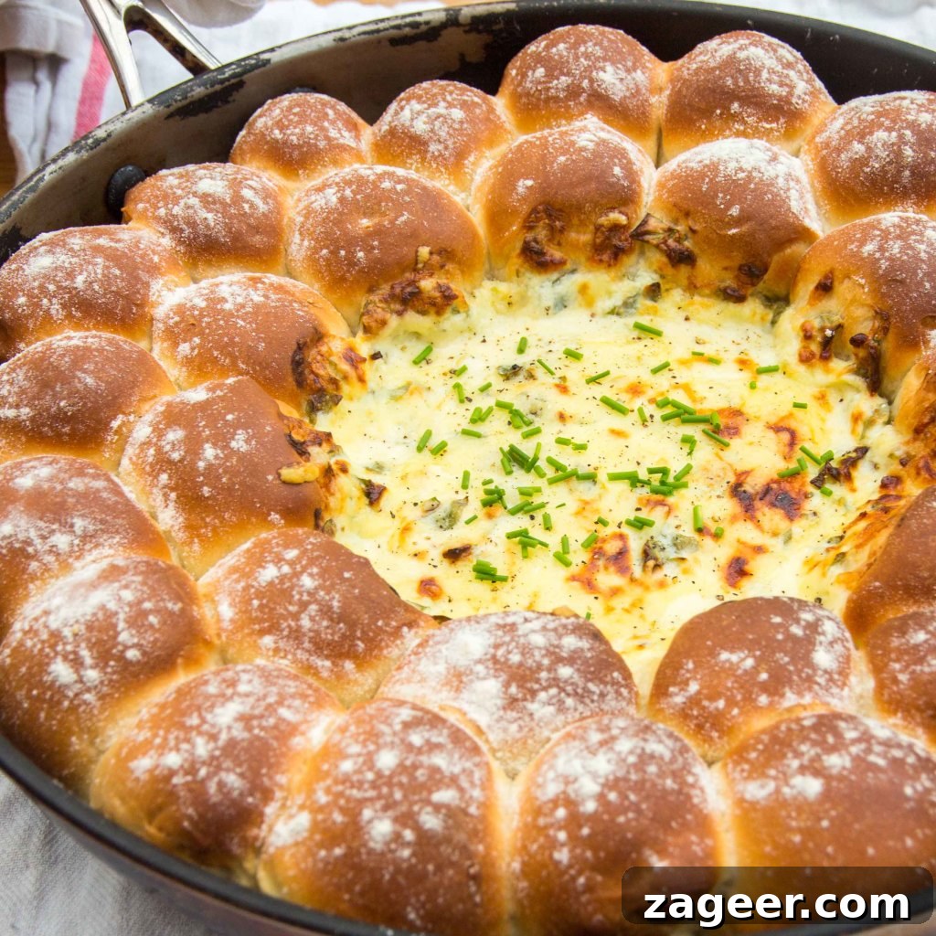 Savory Chard & Cheese Fondue with Golden Dough Bites 2 Delicious Skillet Dough Balls with Cheesy Chard Dip, served directly from the pan, ready for sharing.