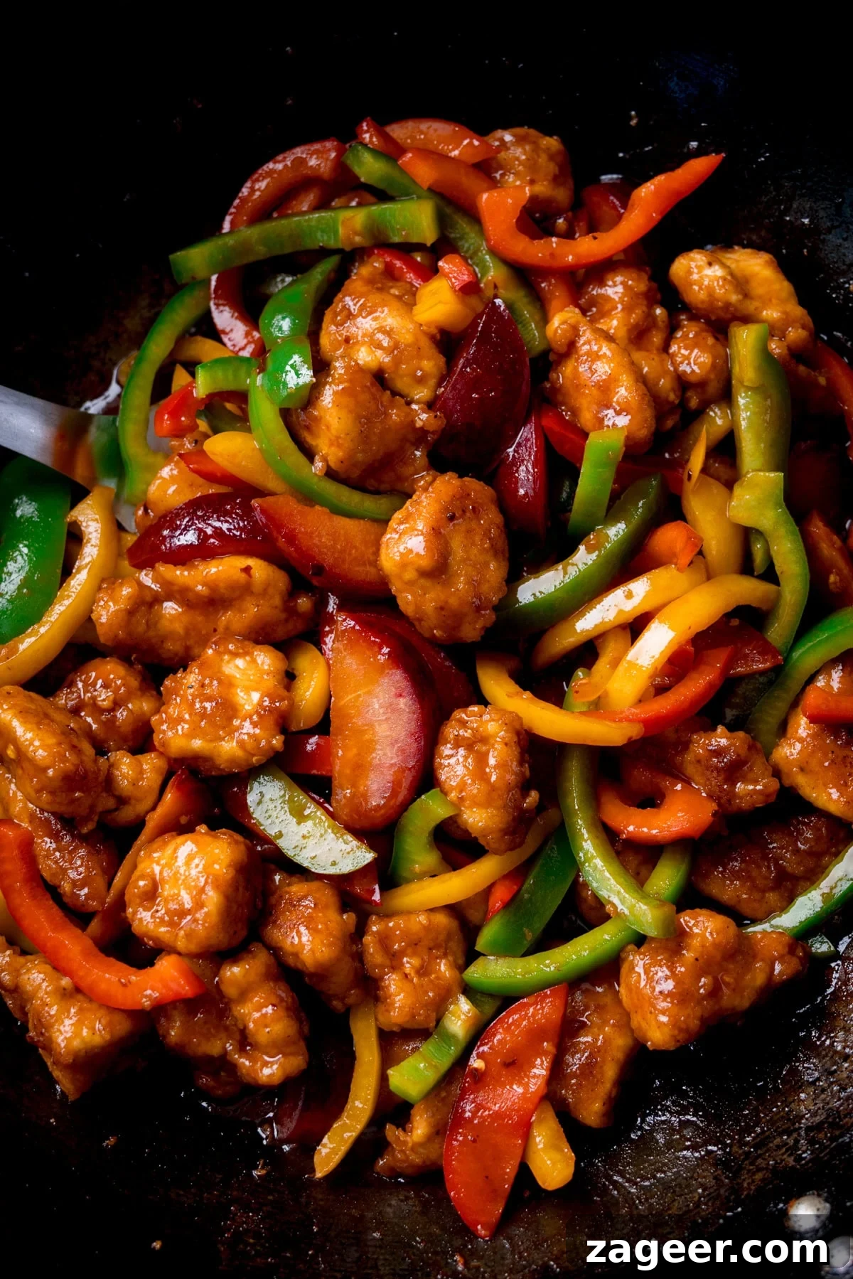 Imperial Plum Chicken Stir-Fry 2 Close up overhead image of Chinese plum chicken stir fry with sliced peppers in a wok.