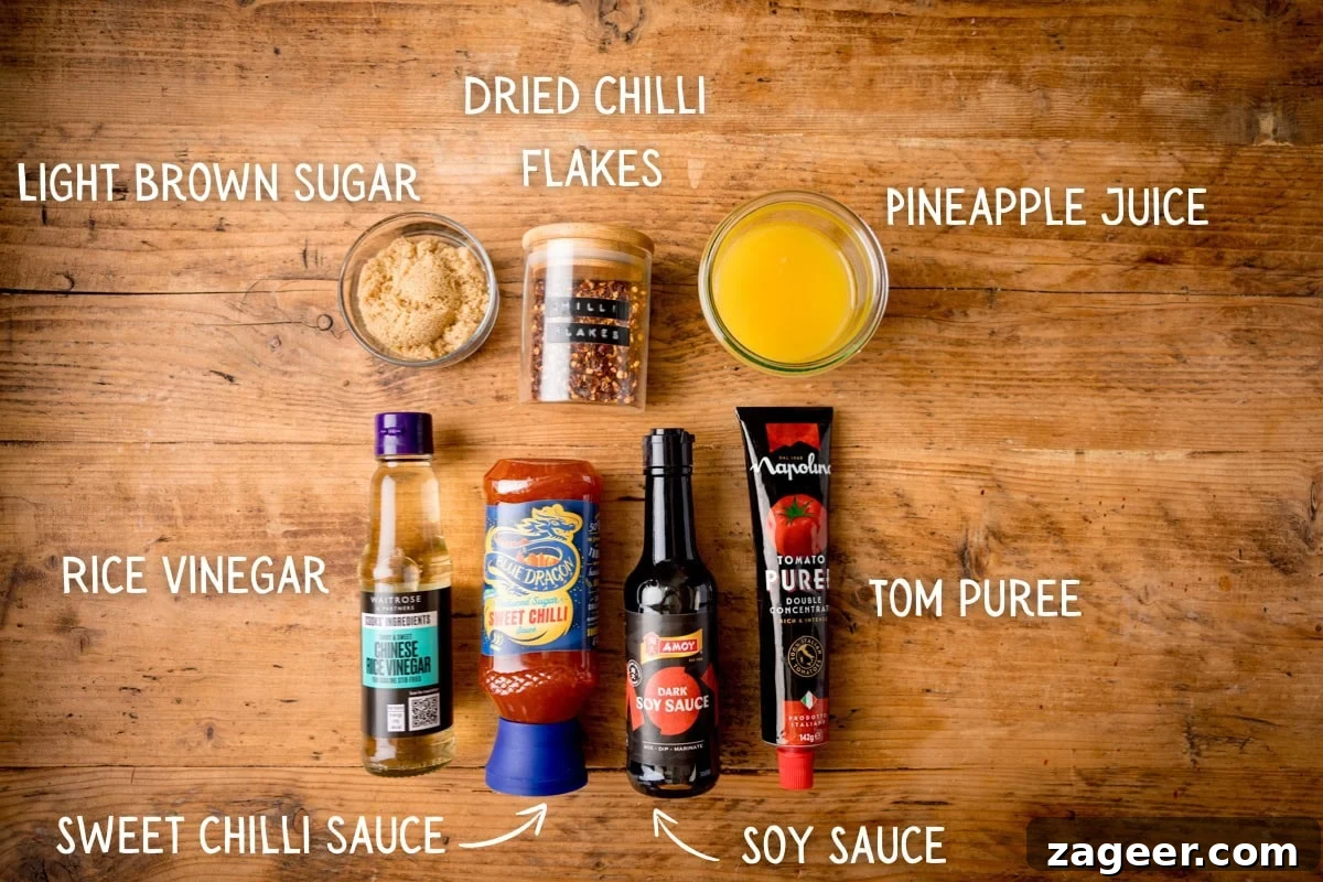 Imperial Plum Chicken Stir-Fry 4 Ingredients for Chinese Plum Chicken Sauce, including sugar, chilli flakes, pineapple juice, rice vinegar, sweet chilli sauce, soy sauce, and tomato purée, on a wooden surface. Each ingredient is labelled.