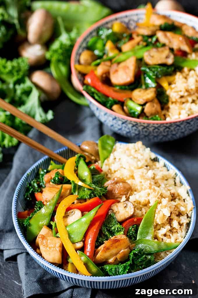 Sticky Honey-Garlic Chicken Stir-Fry with Cauli Egg Fried Rice 2 Close-up of a vibrant Honey and Garlic Chicken Stir Fry with Cauliflower Egg Fried Rice, garnished with fresh herbs