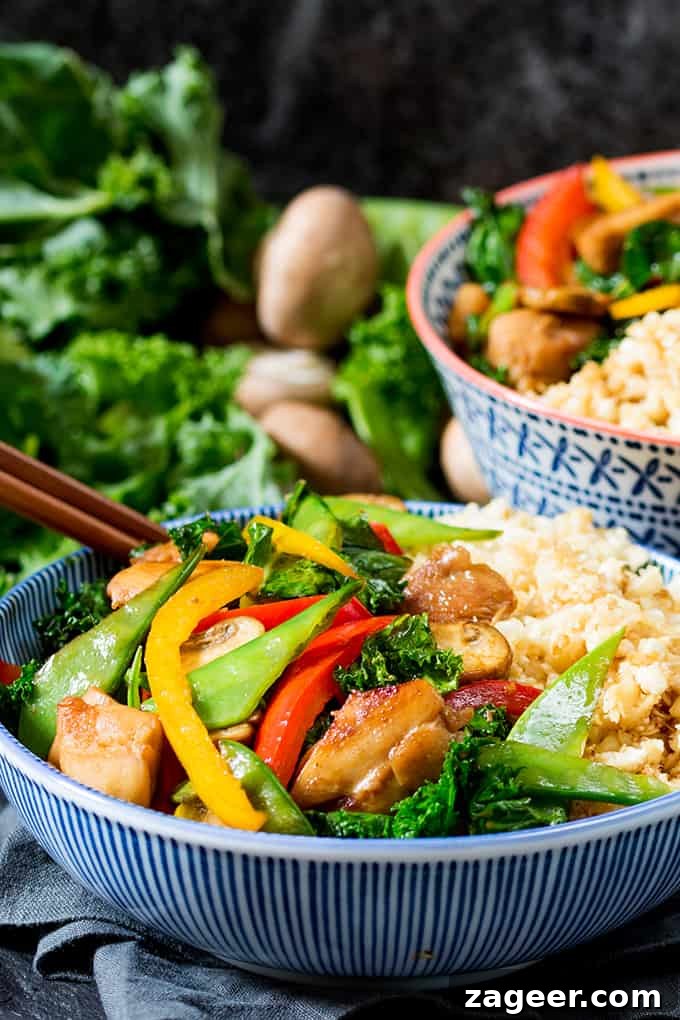 Sticky Honey-Garlic Chicken Stir-Fry with Cauli Egg Fried Rice 3 A serving of homemade Honey and Garlic Chicken Stir Fry with a side of golden Cauliflower Egg Fried Rice on a plate