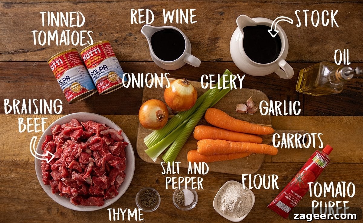 Essential Ingredients for Rich Beef Ragu Ingredients for beef ragu laid out on a wooden table, including beef, vegetables, wine, and canned tomatoes.