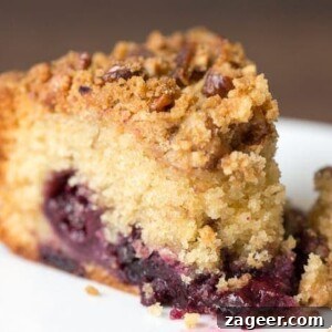 Rustic Cherry Crumble Cake 4 A slice of cherry crumble cake on a plate