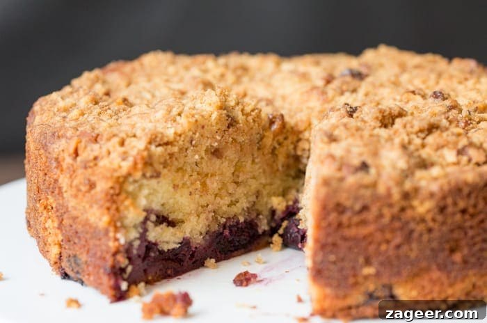 Rustic Cherry Crumble Cake 5 Close up of a Cherry Crumble Cake with a slice taken out