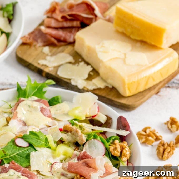 Crisp Winter Delight: Apple Fennel Salad with Prosciutto and Grana 2 Close up photo of Fennel and Apple Winter Salad with Grana Padano and Prosciutto Di San Daniele in the background