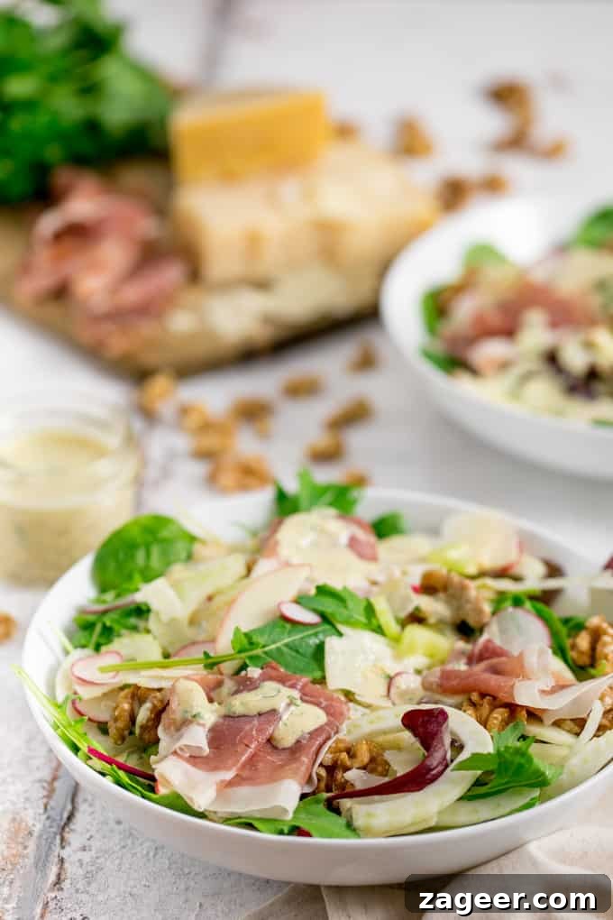 Crisp Winter Delight: Apple Fennel Salad with Prosciutto and Grana 4 Side view photo of Fennel and Apple Winter Salad with Italian ingredients blurred in the background