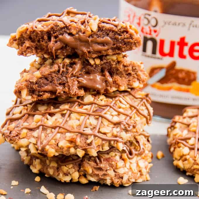 Gluten-Free Hazelnut Nutella Cookies Recipe 2 Gluten Free Hazelnut Nutella Cookies - Soft oat flour chocolate biscuits, rolled in hazelnuts and filled with a gooey chocolate centre.