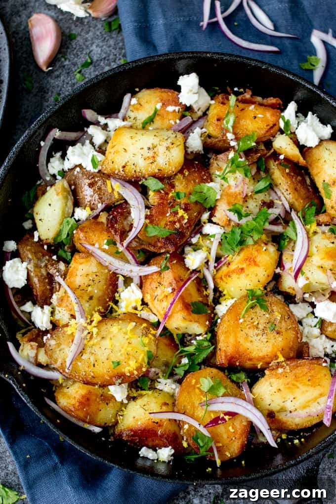 Greek-Style Potato Hash with Feta and Herbs 4 Pan of fried Greek potatoes with feta, red onion and parsley on a blue background.