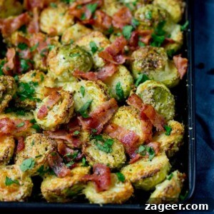 Crispy Baked Parmesan Brussels Sprouts with Bacon 2 Square image showing array of roasted sprouts with bacon bits
