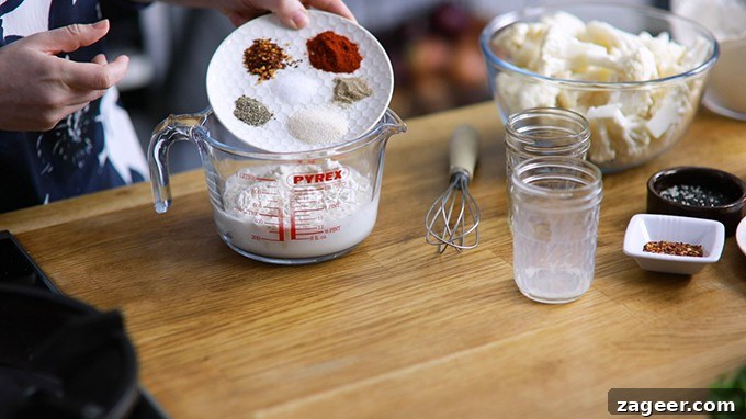 Asian-Style Baked Cauliflower Wings: Sticky Sesame Chili Recipe 3 Spices being poured from a plate to a jug to make coating for baked cauliflower wings