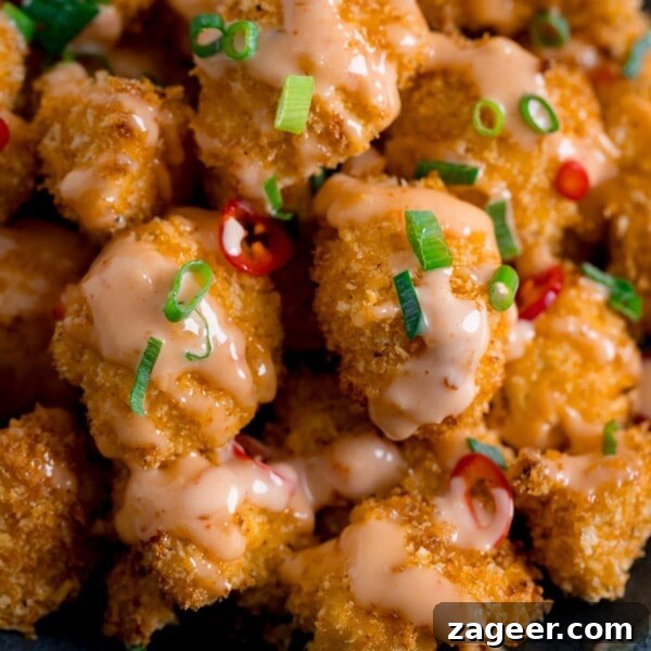 Asian-Style Baked Cauliflower Wings: Sticky Sesame Chili Recipe 10 Close up of Crispy Cauliflower with bang bang sauce topped with chillies and spring onions