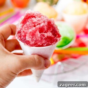 Square image of hand holding cherry flavoured snow cone