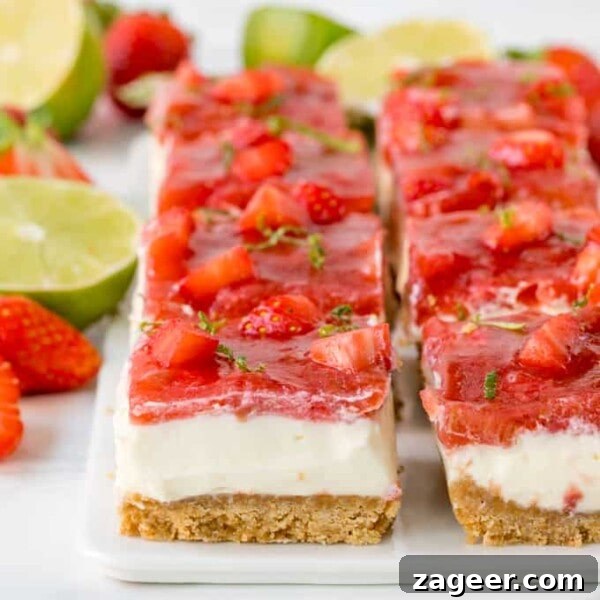 Mini No-Bake Berry Cheesecakes: Individual Dessert Cups 15 Square image of strawberry and rhubarb cheesecake bars with jelly topping and lime zest sprinkled on top