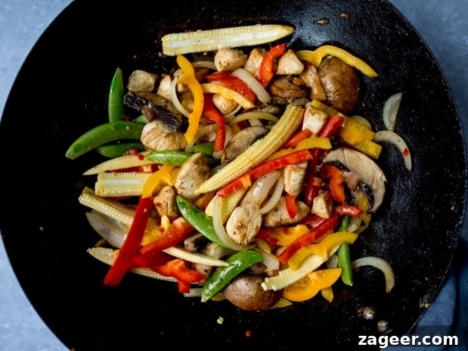 Honey-Soy Chicken Stir-Fry with Spicy Asian Noodles 6 Chicken and vegetables frying in a wok