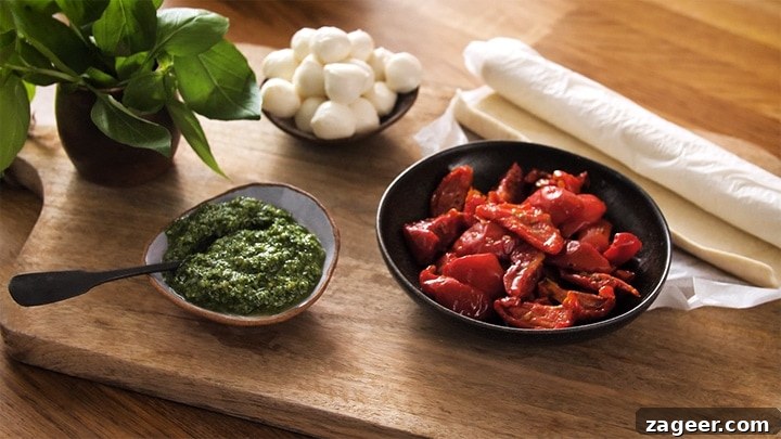 Caprese Puff Pastry Bites: Tomato, Basil & Mozzarella Appetizers 3 chopping board with sundried tomatoes, pesto, pastry and mozzarella