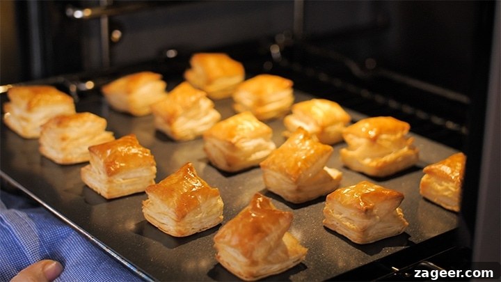 Caprese Puff Pastry Bites: Tomato, Basil & Mozzarella Appetizers 5 Puff pastry squares coming out of the oven