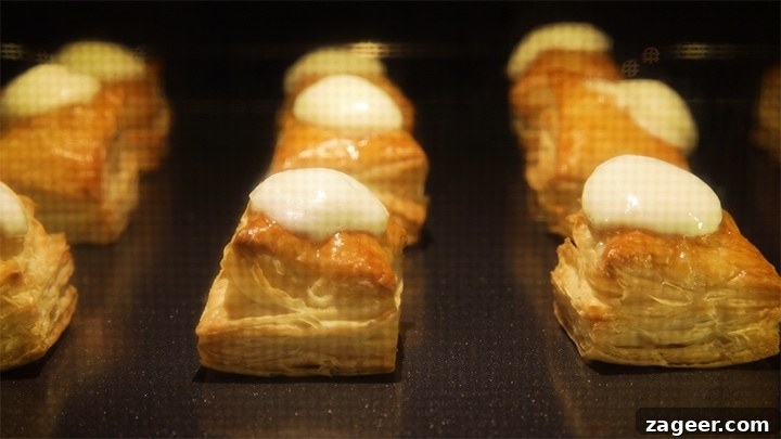 Caprese Puff Pastry Bites: Tomato, Basil & Mozzarella Appetizers 6 Mozzarella melting on puff pastry squares