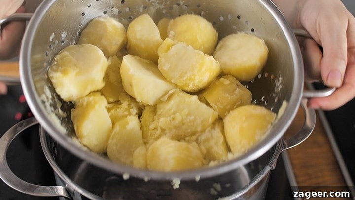 Boiled Potatoes being shaken in a colander