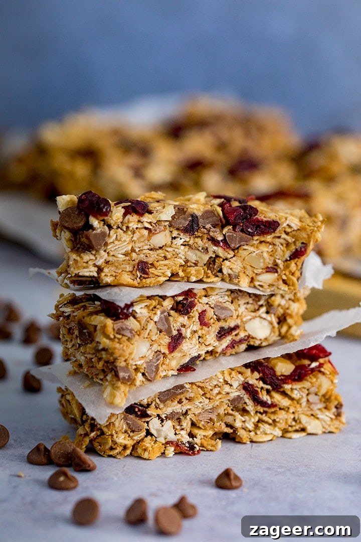 No-Bake Peanut Butter Granola Bars Recipe (Quick & Chewy) 2 3 stacked Peanut Butter Granola Bars with more granola bars in the background