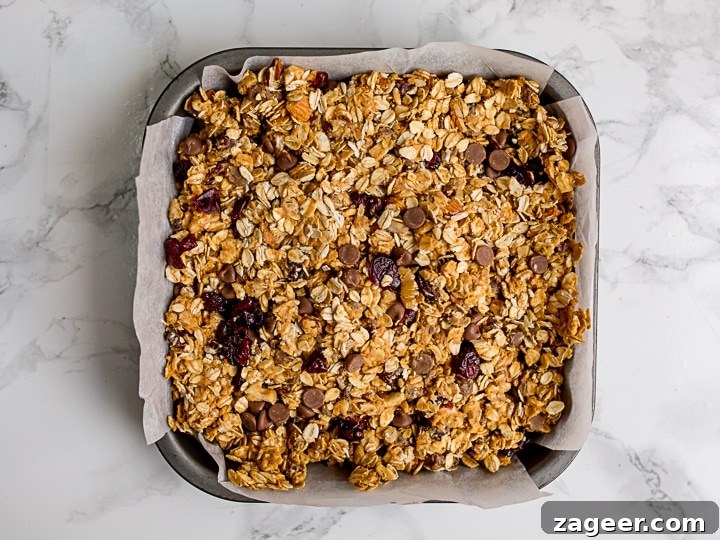No-Bake Peanut Butter Granola Bars Recipe (Quick & Chewy) 6 Granola bar mixture in a baking tin