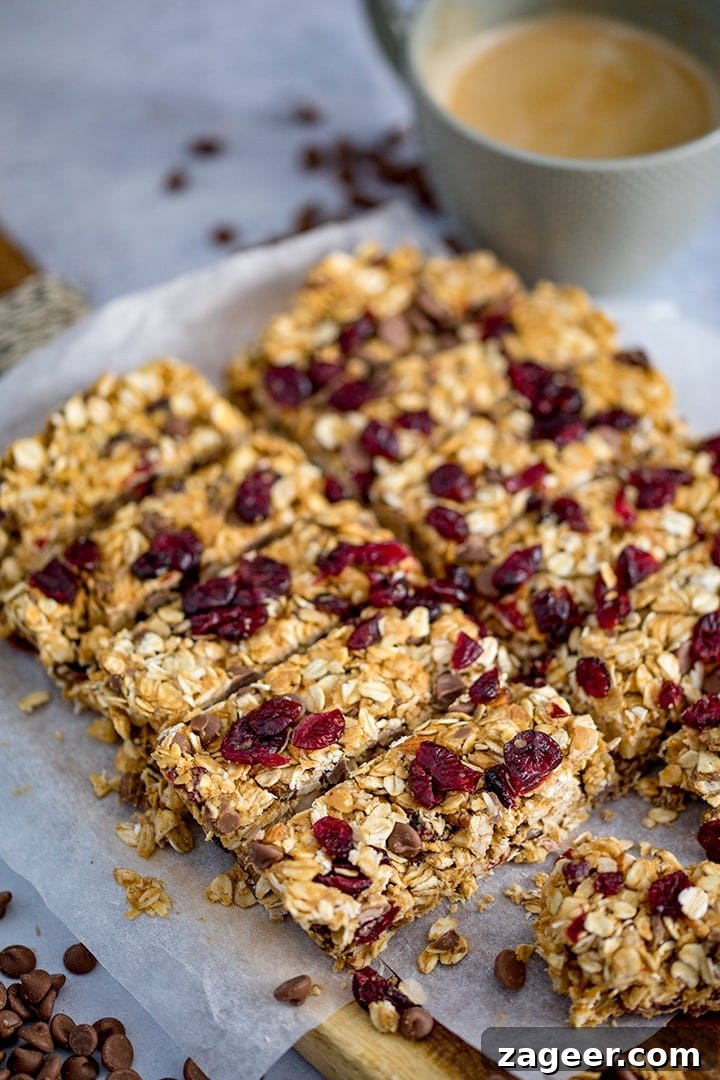No-Bake Peanut Butter Granola Bars Recipe (Quick & Chewy) 8 Peanut Butter Granola Bars with cranberries and chocolate chips on a chopping board