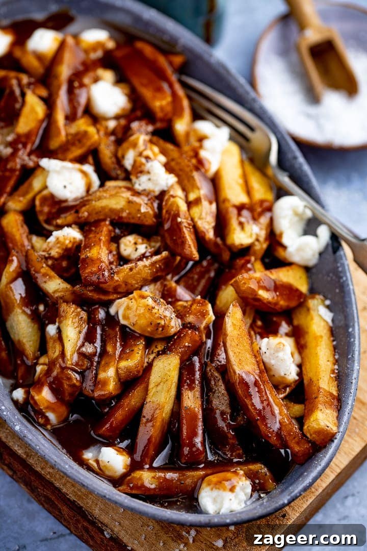 Classic Canadian Poutine Recipe: How to Make Authentic Poutine at Home 2 Overhead image of Poutine in a grey dish