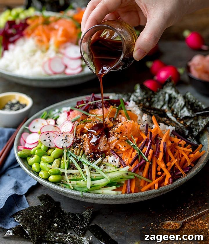Salmon Sushi Bowl Recipe: Homemade Poke-Style Salmon Bowl 2 Sushi salmon bowl with dressing being poured on