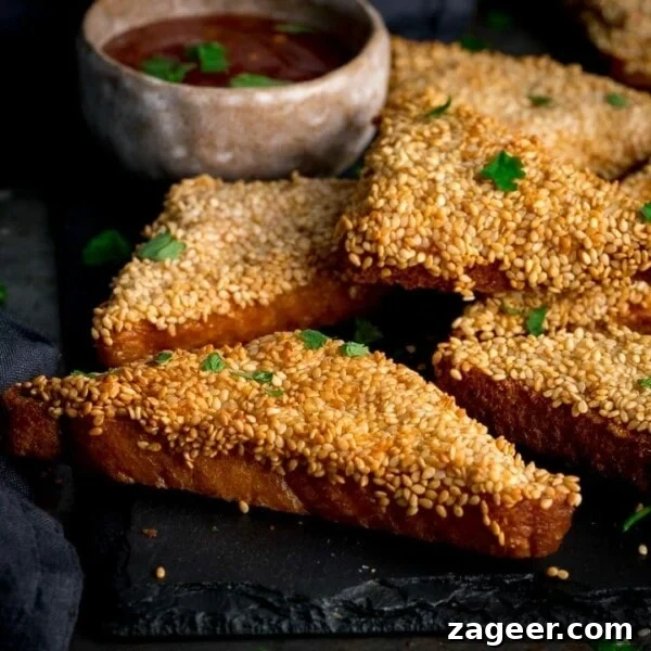 Crispy Coconut Shrimp Recipe with Mango Dipping Sauce 7 Prawn toast on a black serving board